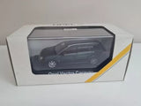 Diecast model car in box packaging, dark gray station wagon with visible wheels