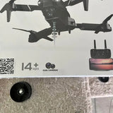 Retail box showing black drone with dual cameras label