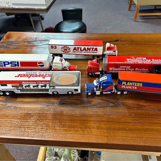 Diecast toy truck set with red, blue, and white trucks and trailers