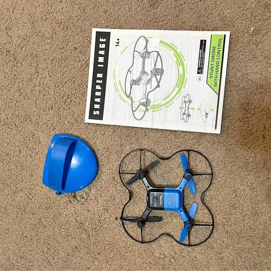 Blue stunt drone with prop guards, four rotors, and foldable arms