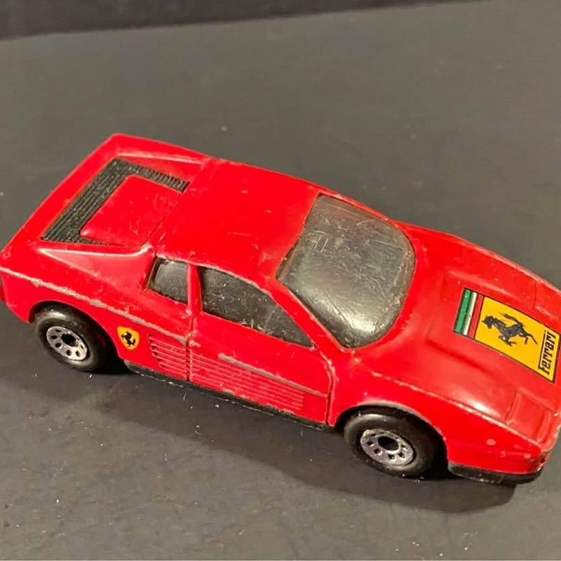 Red vintage Ferrari Testarossa diecast sports car model with black wheels