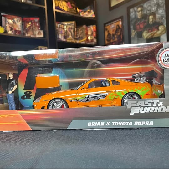 Orange diecast car with Brian figure in retail box, Fast & Furious branding