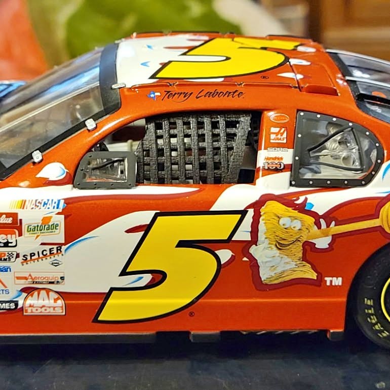 Orange and white diecast stock car with large yellow number 5 on hood