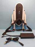 Folded quadcopter drone with attached propellers, battery pack and charging cables