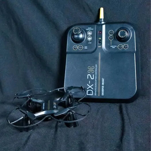 DX-2 drone with black remote controller, antennas visible