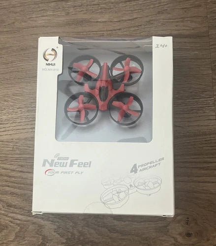 Red and black mini quadcopter drone in retail box, 4 propellers