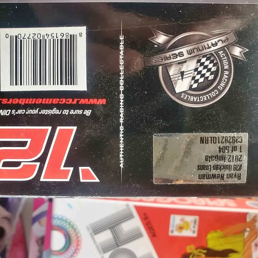 1:24 diecast car packaging close-up with barcode and racing logo