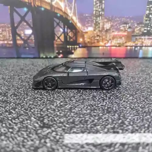1/64 black carbon-style diecast sports car toy with detailed wheels