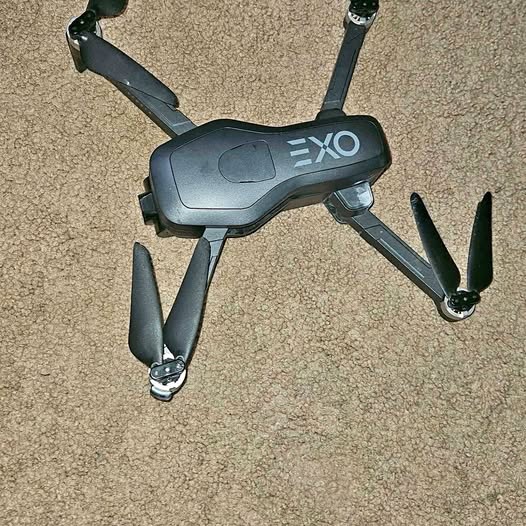 Drone with dark gray body, EXO marking, and four prop arms