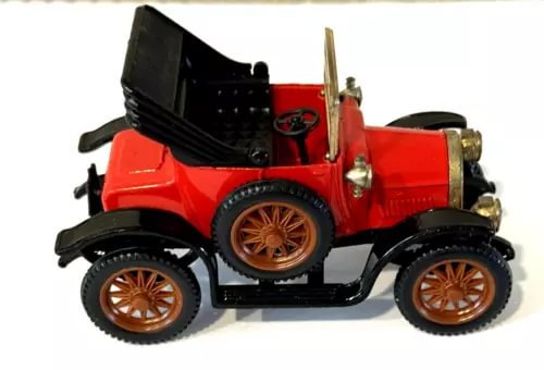 Red and black diecast toy car with wooden-style wheels, side view, open-top
