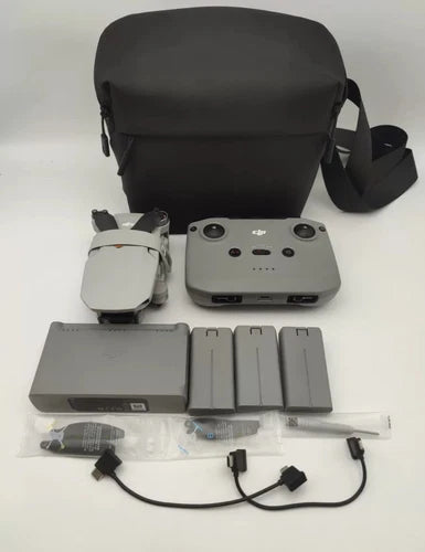 Drone accessories kit with black carry case, controller, batteries, and chargers