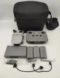 Drone accessories kit with black carry case, controller, batteries, and chargers