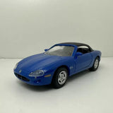 Diecast model car toy of a blue Jaguar XK8 coupe, front three-quarter view
