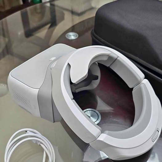 DJI FPV goggles headset in light gray with curved display window and strap