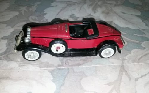 ERTL red diecast 1:43 Packard boattail speedster model car, black trim, side view