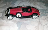 ERTL red diecast 1:43 Packard boattail speedster model car, black trim, side view