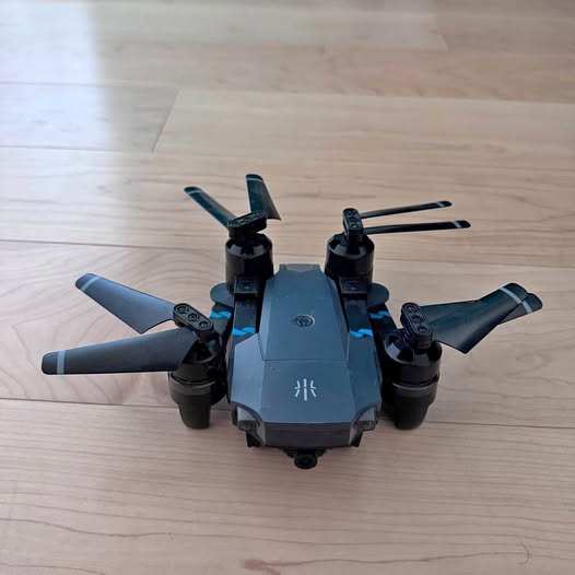 UranHub foldable drone, dark blue body with four rotating propellers