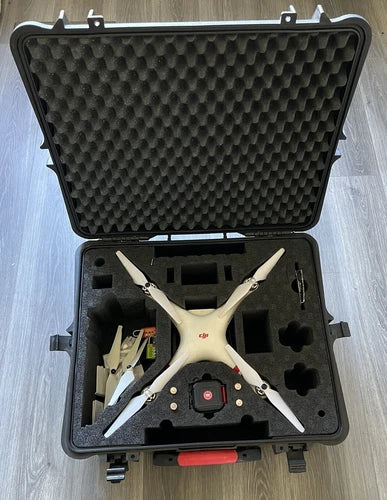 Quadcopter drone with four propellers in molded hard case with accessories