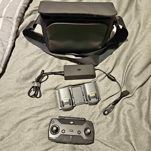 DJI Spark drone controller with black carrying case, cables, and charging adapter