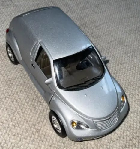 2000 PT Cruiser diecast car in light gray/silver, front 3/4 view with headlights