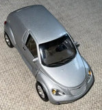 2000 PT Cruiser diecast car in light gray/silver, front 3/4 view with headlights