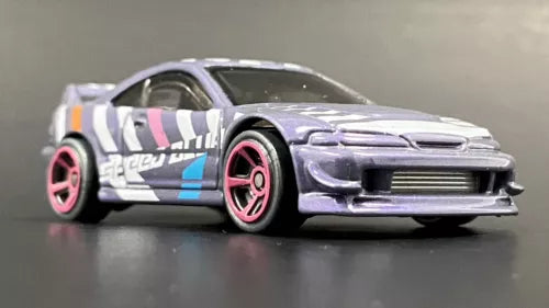 White diecast model car with pink wheels and blue stripe, front 3/4 view