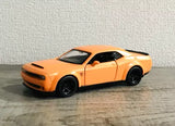 Matte orange diecast sports car model with hood vents and black wheels