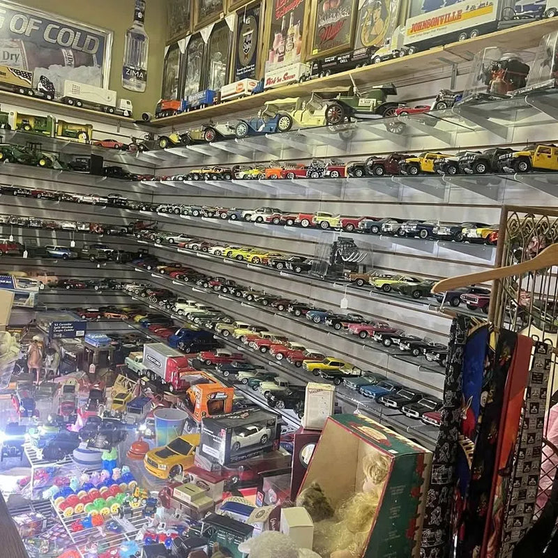 Diecast car model display with rows of miniature vehicles in various colors