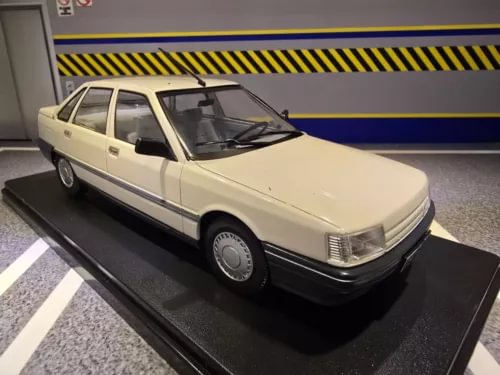Beige diecast model sedan car on black display base