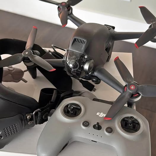 DJI FPV drone with gray body, front camera, and 4 propellers