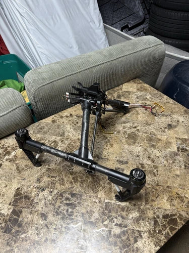 DJI Inspire 1 drone frame with four arms and camera mount, partially assembled