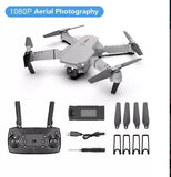 Foldable quadcopter drone with controller, batteries, and spare propellers set