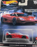 Red diecast model car in clear blister pack, Koenigsegg Agera R design