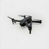 Dark gray quadcopter drone with four propeller arms and camera body