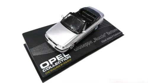 Silver diecast model car on black display base with OPEL Collection text