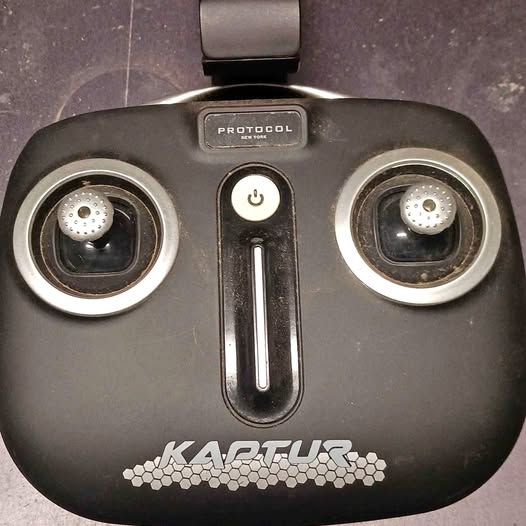 Black Kaptur drone controller with power button and two circular control sticks.