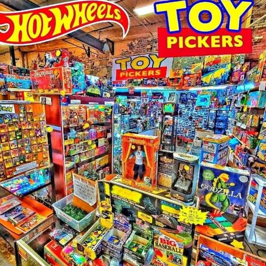 Hot Wheels toy trading card packs and boxed collectibles on store shelf