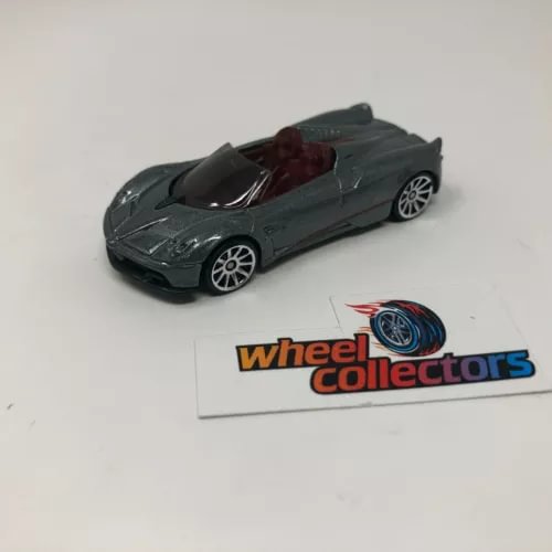 Pagani Huayra Roadster diecast model car, dark green convertible with detailed wheels
