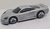 Silver 1:64 diecast sports car with black windows and hood detail