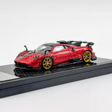 1/64 scale diecast sports car model in red with gold wheels