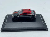 Black diecast coupe model car with red roof, front view on display base
