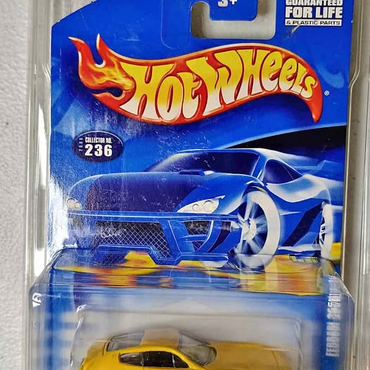 Hot Wheels diecast race car in blister packaging, blue and yellow flame design.