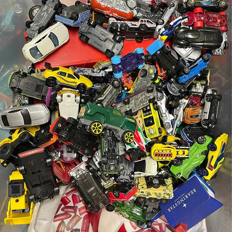 Assorted colorful die-cast toy cars with wheels and decals, various models
