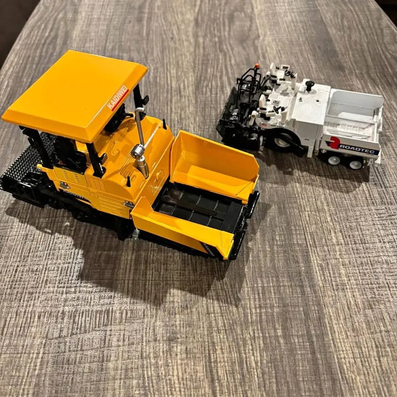Yellow diecast paver machine model with curb attachment and control console
