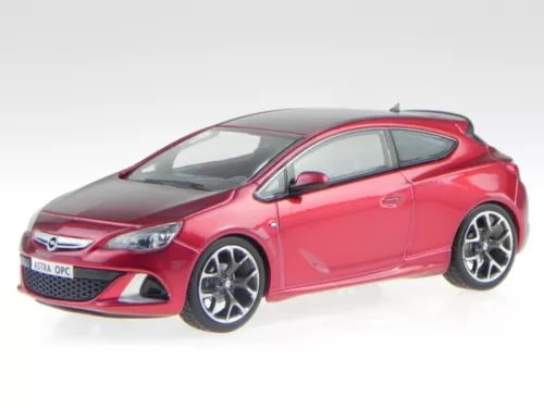 Red diecast model car with open wheels and front grille, side view