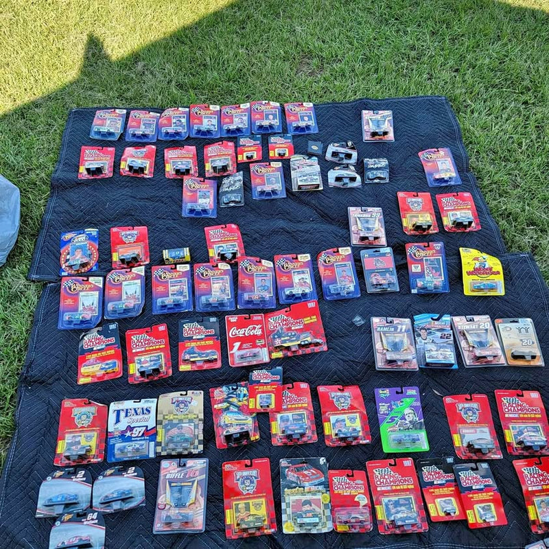 NASCAR diecast collection: assorted boxed race car models on blue mat