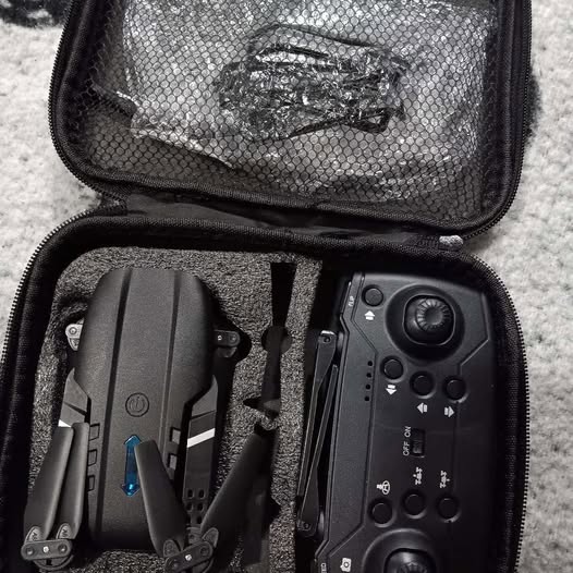 Kids RC drone controller and spare parts in zippered carrying case