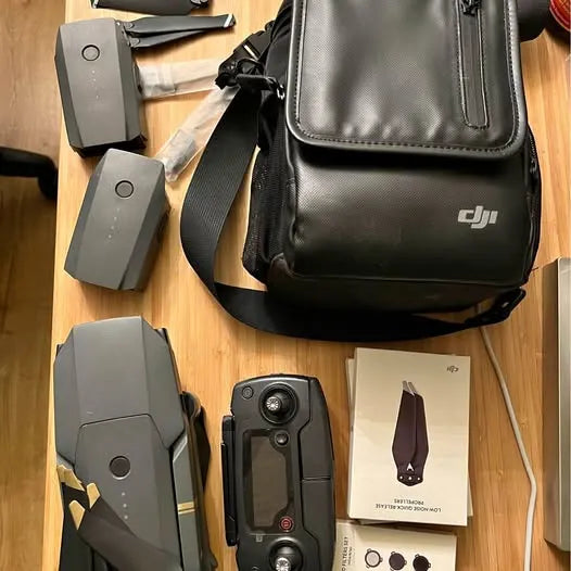 DJI drone accessories set with gray batteries, remote, and black shoulder bag
