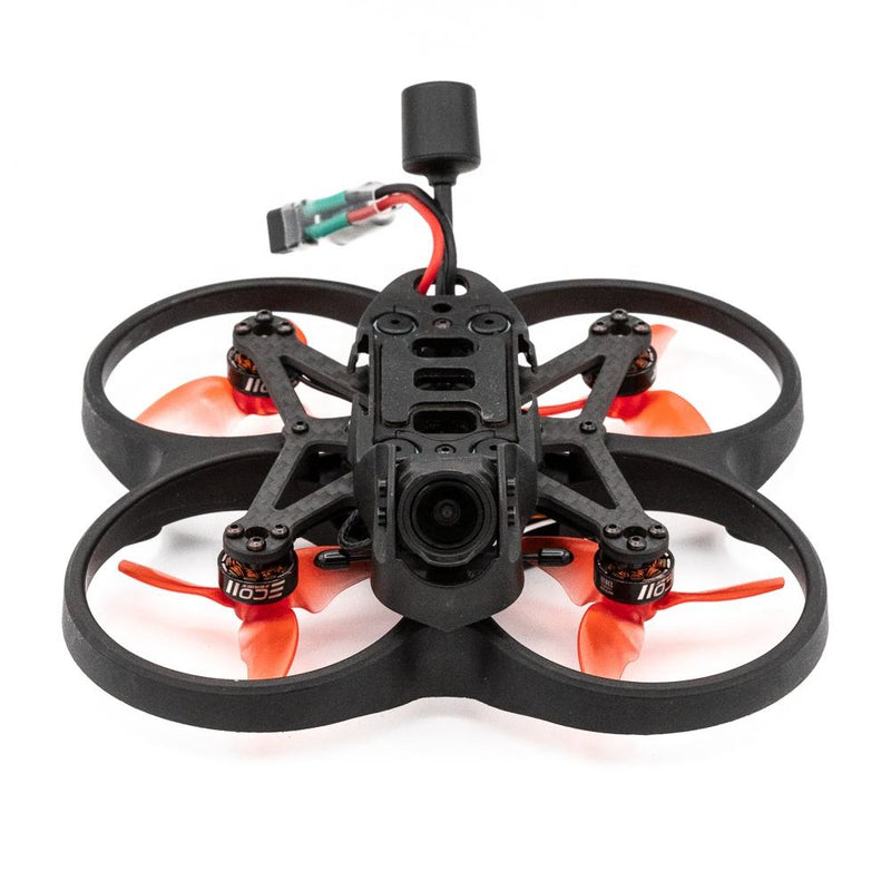 Mini racing drone with black frame, orange propellers, front camera and antenna.