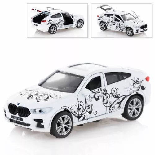BMW X6 diecast model car, white with decorative swirls, detailed front grille and alloy wheels